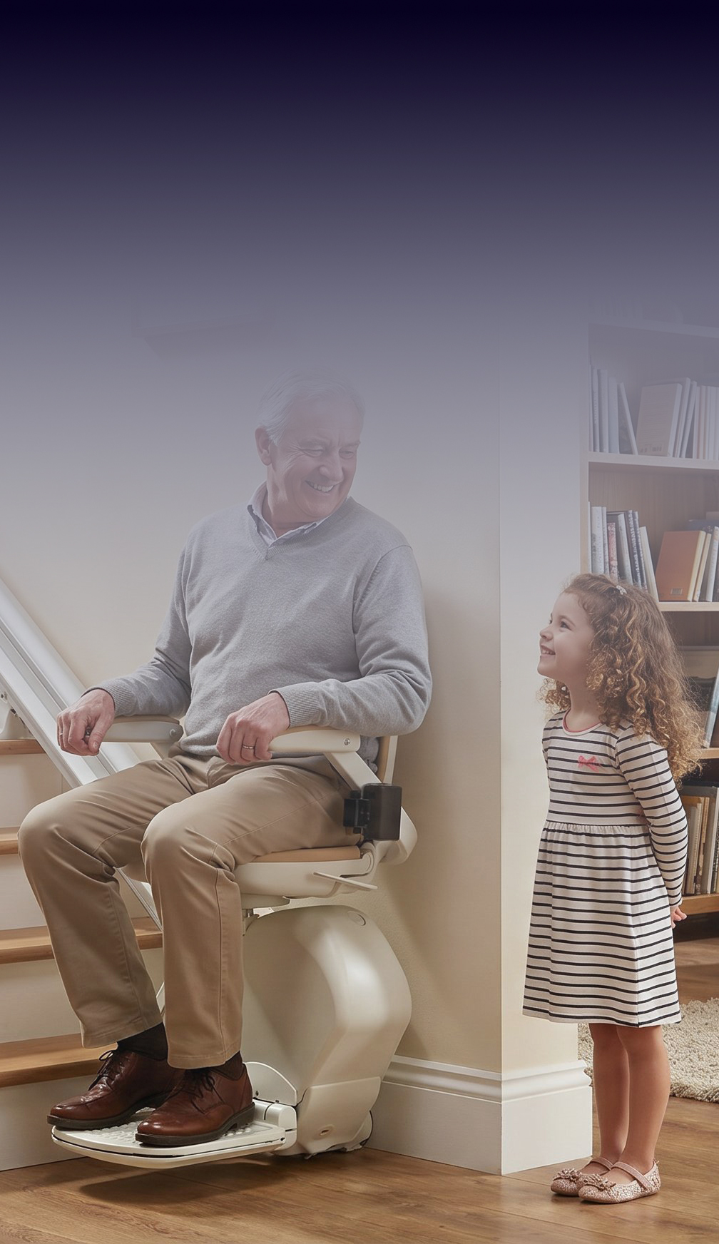 Older man using a stairlift safely at home with his granddaughter nearby